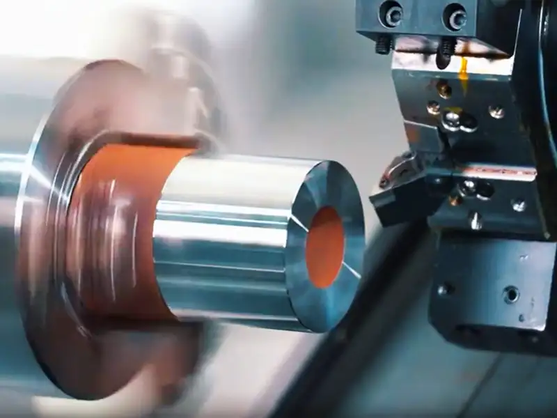CNC turning process machining a cylindrical metal part on a lathe