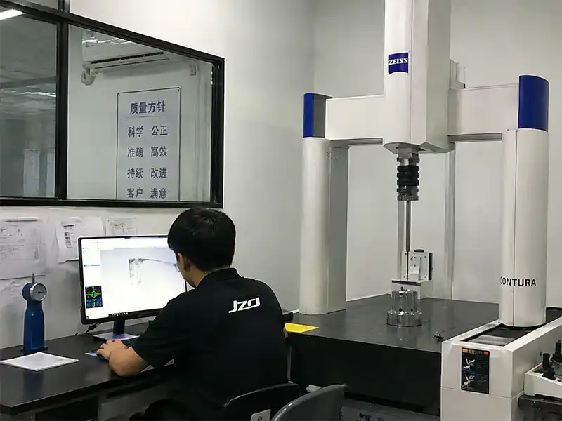 JIZAO quality technician using a ZEISS CONTURA CMM to perform dimensional inspection on a precision CNC machined metal part in a Shenzhen, China quality-control room.